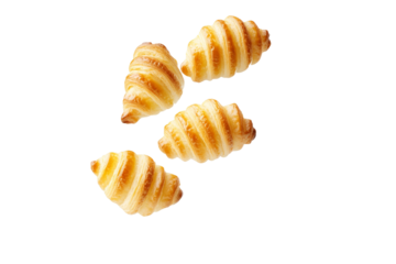 Three croissants are shown in the air, isolated