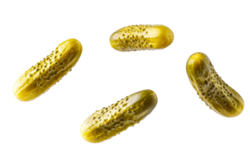 Four pickles are flying through the air, isolated