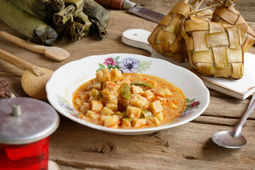 Close up of tofu rambak vegetables, potatoes with red syrup drink. Tofu vegetables are a side dish for Ketupat, a typical dish during Eid al-Fitr in Indonesia.