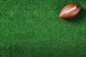 Football is laying on a green field