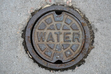 Water manhole. Access to water mains. Slightly rusted steel.