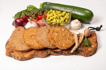 Round vegetarian patties or burgers made from grains, soybeans, vegetables and legumes