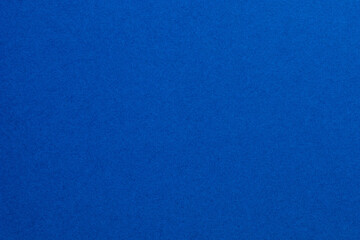 A blue background with a few white dots, textured origami paper backdrop