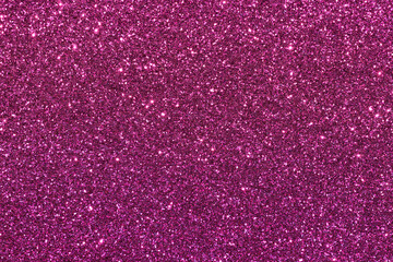 A close up of a pink glittery surface
