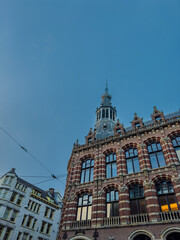 Aerial view of Amsterdam, Netherlands showcases its iconic canal houses, Dutch architecture, and boat tours along the waterfront, capturing the charm of this historic European cityscape