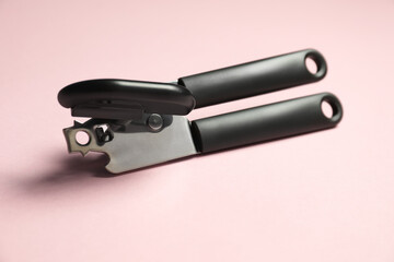 One can opener on pink background, closeup