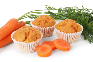 Tasty carrot muffins and fresh vegetables isolated on white