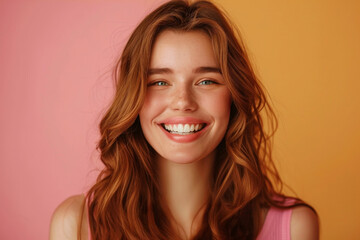 Fototapeta premium Vibrant portrait of a young woman with natural beauty and a genuine smile. Expression of happiness and confidence on a pastel background, highlighting her positive energy and radiant charm.