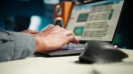 Independent worker balancing freelance tasks and researching articles, starting his day answering emails. Young adult typing project notes, gathering information for work improvement. Camera A.