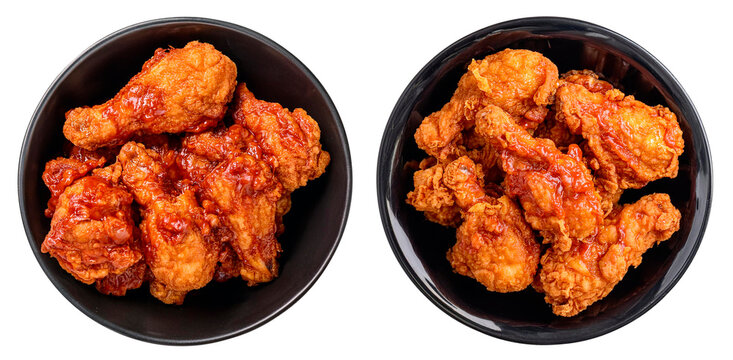 top view of two bowls of crispy fried chicken smothered by red spicy sauce isolated on white background