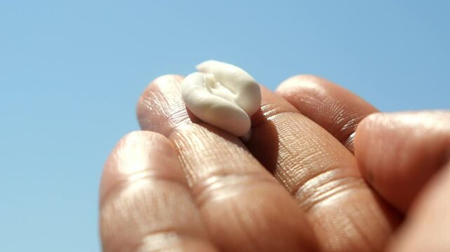 Applying sunscreen to skin for sun protection outdoors