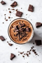 Chocolate frappe in a transparent glass on a white background 