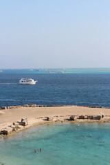 Red sea seascape with tourists swimming on a sunny day in Hurghada, Egypt