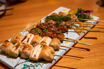 Delicious dishes from a Japanese yakitori restaurant, various yakitori skewers