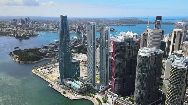 Drone video rotating around the CBD from behind Barangaroo revealing Sydney Harbour and the coastline in the distance