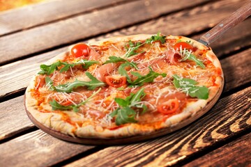 Thin crust tasty pizza Margherita with tomatoes and basil.