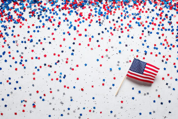 Obraz premium American flag waving proudly in front of a confectionery shop filled with colorful treats.