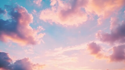 Fototapeta premium Scenic view of clouds in the sky at sunset with warm golden and orange hues, creating a peaceful and dramatic atmosphere. Nature, weather, and evening sky landscape concept.