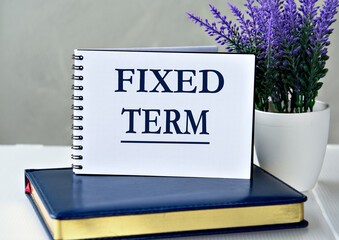FIXED TERM - words in a notebook against the background of a diary and lavender
