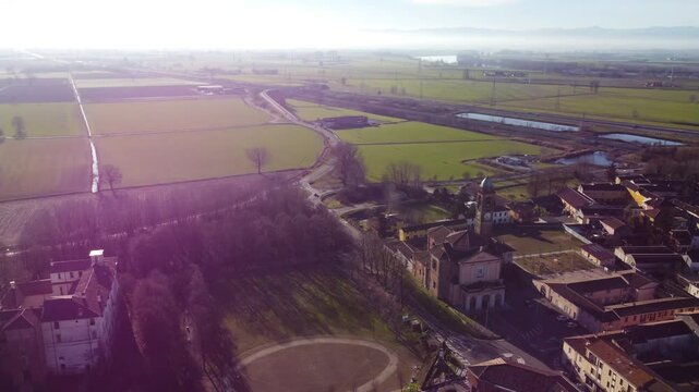 little church next to Somaglia gas Station. next to the train rails in a beautiful sunset.