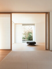 Fototapeta premium Tranquil interior of a modern Japanese-inspired space with natural light and greenery