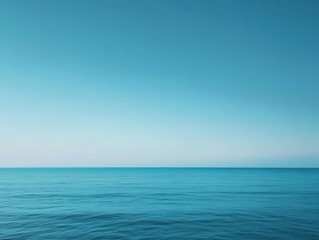 Obraz premium Serene Ocean View with Calm Waters and Clear Blue Sky Reflecting Light in a Tranquil Coastal Setting Perfect for Relaxation and Nature Photography