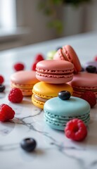 Fototapeta premium close-up shot of colorful macarons with fresh raspberries and dark berries, arranged on a marble surface, suggesting a bright, modern, and elegant dessert setting.