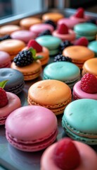 Obraz premium Close-up shot of colorful macarons with fresh raspberries and dark berries, arranged on a marble surface, suggesting a bright, modern, and elegant dessert setting.