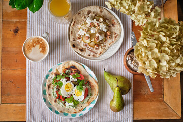 Flatbread with curd-cilantro paste, grilled pepper and eggplant, homemade cheese and boiled egg. Flatbread with curd-fig paste with stewed pear, homemade cheese and hazelnuts.