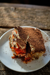 A piece of tiramisu with red savoiardi
