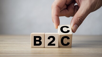 B2B to B2C Business Transition Concept – Hand Adjusting Wooden Cubes Representing Business Model Shift