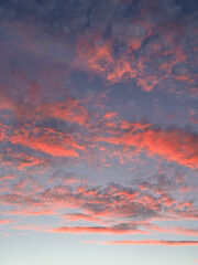 A beautiful pink and blue sky with clouds. The sky is a mix of colors, with the blue sky being the dominant color. The clouds are scattered throughout the sky, with some being larger