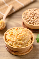 Miso paste in wooden bowl, Japanese seasoning made from fermenting soybeans with salt, Traditional food ingredient in Japanese cuisine