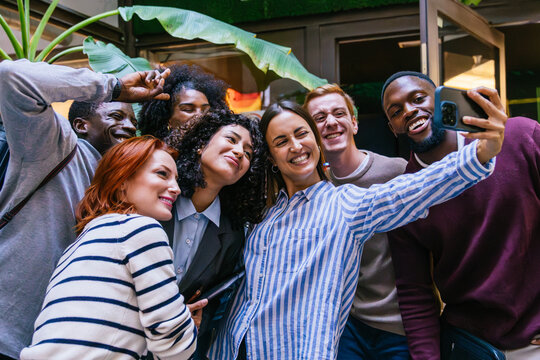 Happy multi ethnic business team taking a selfie in the office courtyard