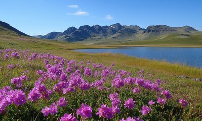 Fototapeta premium Vibrant Pink Flowers Blooming by Serene Lake with Majestic Mountains under Clear Blue Sky in Tranquil Nature Landscape