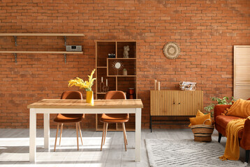 Interior of comfortable living room with table, chairs and shelving unit
