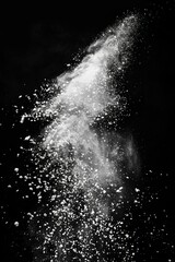 Dramatic splash of white powder on black background
