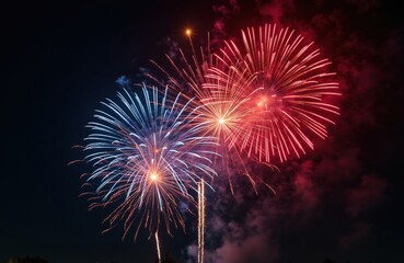 Vibrant red, blue fireworks illuminate night sky, celebrate Independence Day. Festive pyrotechnic display bursts with light. Anniversary carnival tradition shows shiny starburst sparks, American flag