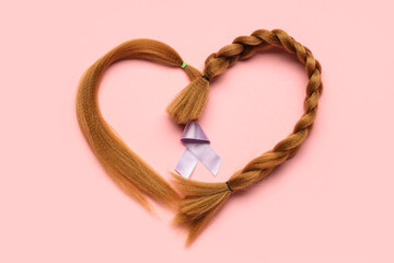 Heart made of red hair strands for donation and purple awareness ribbon on pink background