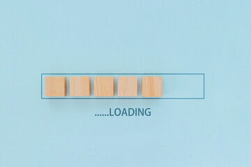 Wooden blocks in a loading bar design, symbolizing progress or buffering.