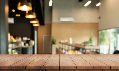 Empty wooden table top with lights bokeh on blur restaurant background.