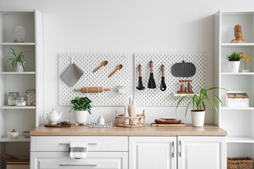Shelving units, counter and peg board in kitchen