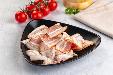 Raw pork tenferloin with bacon