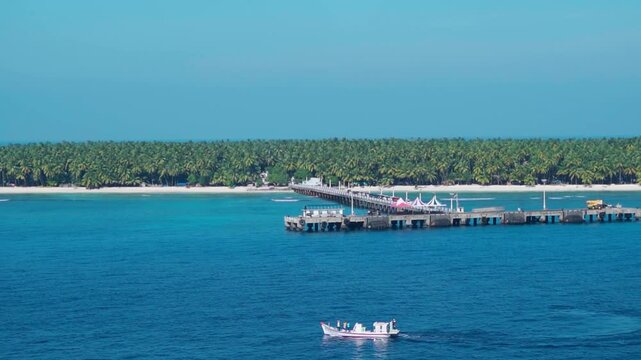 Blue water of ocean and cement jetty at Agatti Island in Lakshadweep, India. Calm sea and jetty at cost side. Island beach vacation during summer.
