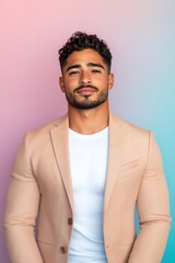 Fototapeta premium Stylish Middle Eastern man in pastel beige blazer smirking
