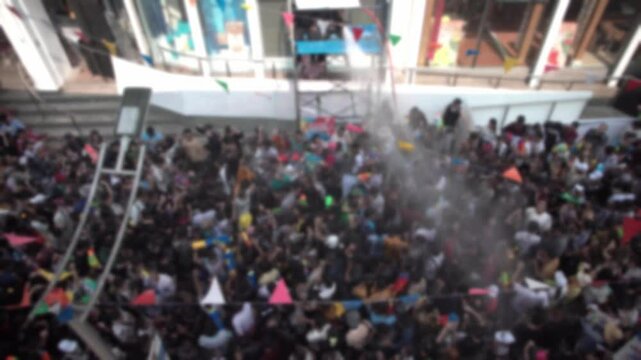 Blurred footage of a crowd celebrating Songkran, Thailand's New Year festival, in Bangkok, Thailand.