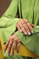 Woman with beautiful manicure sitting on chair, closeup