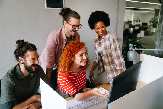 Group of business people and software developers working as a team in office