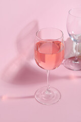 Glass of wine on pink background