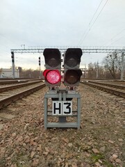 Railway traffic light with stop signal on railroad tracks. View from above.